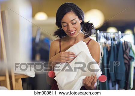 Mixed race woman holding fabric in store View Large Photo Image Stock Image - Mixed race woman holding fabric in store. Fotosearch