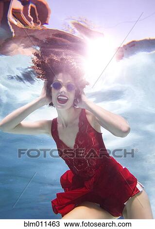 Mixed race woman in clothes swimming underwater View Large Photo Image Stock Image - Mixed race woman in clothes swimming underwater. Fotosearch