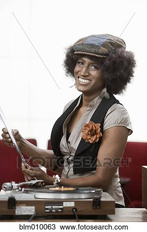 Mixed race woman listening to music View Large Photo Image Stock Image - Mixed race woman listening to music. Fotosearch