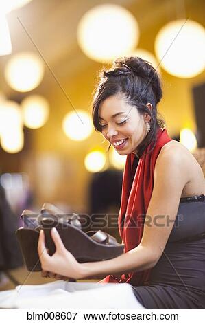 Mixed race woman shopping for shoes in store View Large Photo Image Stock Photo - Mixed race woman shopping for shoes in store. Fotosearch