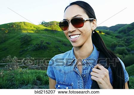 Mixed race woman smiling on rural hilltop View Large Photo Image Stock Photo - Mixed race woman smiling on rural hilltop. Fotosearch