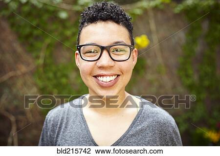 Stock Image - Mixed race woman smiling outdoors. Fotosearch