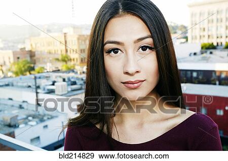 Mixed race woman standing on urban rooftop View Large Photo Image Stock Photo - Mixed race woman standing on urban rooftop. Fotosearch