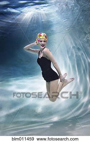 Mixed race woman swimming underwater View Large Photo Image Stock Photo - Mixed race woman swimming underwater. Fotosearch