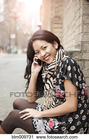 Mixed race woman talking on cell phone View Large Photo Image Stock Image - Mixed race woman talking on cell phone. Fotosearch