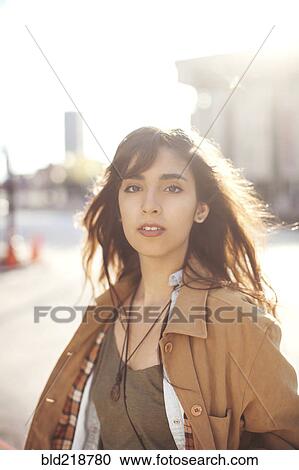 Stock Image - Mixed race woman walking in city. Fotosearch