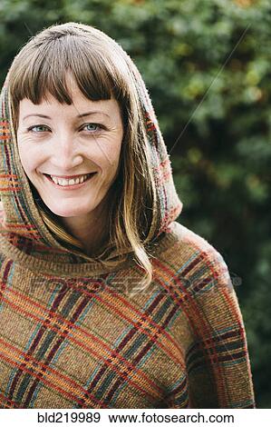 Mixed race woman wearing hood and shawl in backyard View Large Photo Image Stock Photo - Mixed race woman wearing hood and shawl in backyard. Fotosearch
