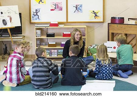 Montessori teacher talking to students in classroom View Large Photo Image Stock Image - Montessori teacher talking to students in classroom. Fotosearch