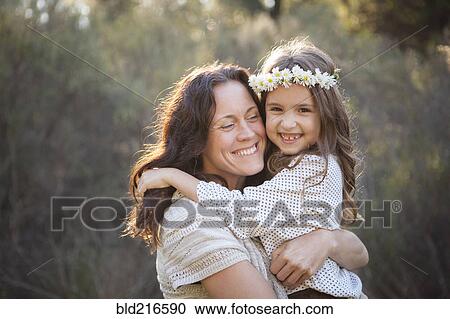 Mother and daughter hugging in park View Large Photo Image Stock Image - Mother and daughter hugging in park. Fotosearch
