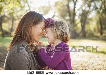 Stock Photography - Mother and daughter hugging in park. Fotosearch