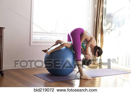Mother and daughter practicing yoga in studio View Large Photo Image Stock Image - Mother and daughter practicing yoga in studio. Fotosearch