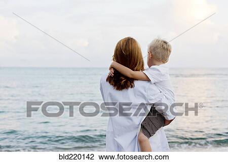 Stock Image - Mother and son admiring ocean. Fotosearch