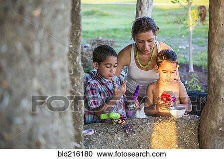Mother and sons playing in backyard View Large Photo Image Stock Image - Mother and sons playing in backyard. Fotosearch