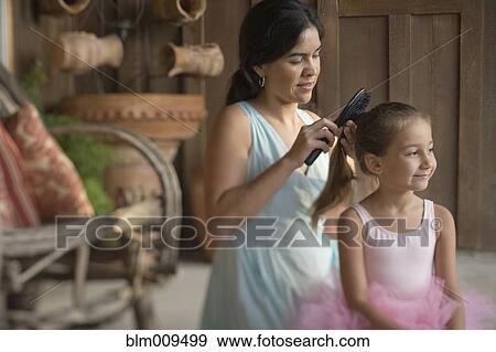 Stock Photo - Mother brushing ballerina's hair. Fotosearch