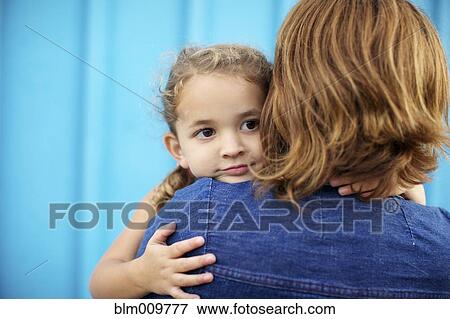 Stock Photo - Mother holding and comforting daughter. Fotosearch