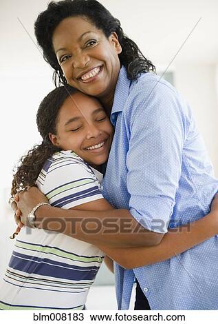 Mother hugging daughter View Large Photo Image Stock Image - Mother hugging daughter. Fotosearch