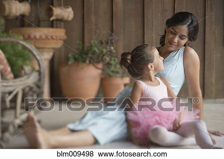Stock Photo - Mother sitting on porch with ballerina daughter. Fotosearch