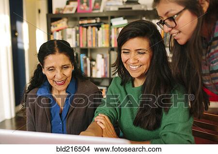 Picture - Multi-generation family of women using computer. Fotosearch