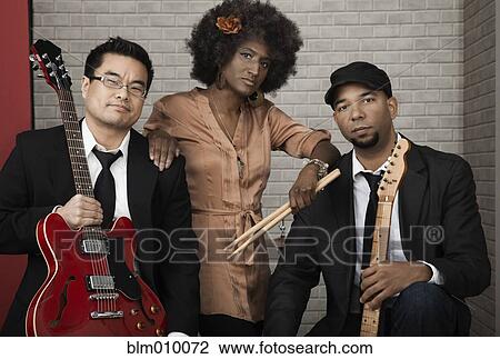Musicians standing together with musical instruments View Large Photo Image Stock Image - Musicians standing together with musical instruments. Fotosearch