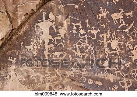 Stock Photo - Native American petroglyphs on rock wall. Fotosearch