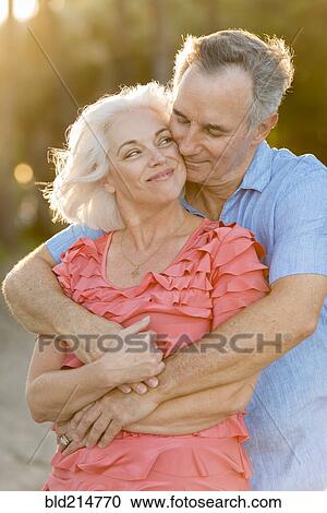 Older Caucasian couple hugging on beach View Large Photo Image Stock Image - Older Caucasian couple hugging on beach. Fotosearch