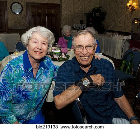 Stock Photo - Older Caucasian couple smiling at party in retirement home. Fotosearch