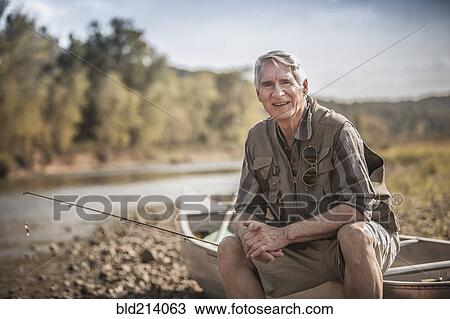 Older Caucasian man holding fishing rod near river View Large Photo Image Stock Image - Older Caucasian man holding fishing rod near river. Fotosearch
