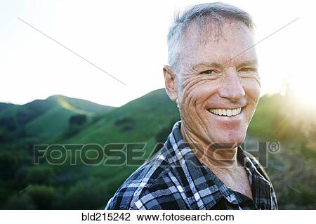 Older Caucasian man smiling on rural hilltop View Large Photo Image Stock Image - Older Caucasian man smiling on rural hilltop. Fotosearch