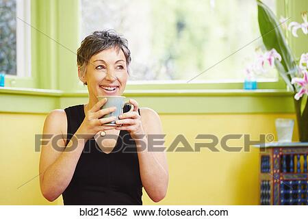 Older Caucasian woman drinking cup of coffee View Large Photo Image Stock Image - Older Caucasian woman drinking cup of coffee. Fotosearch