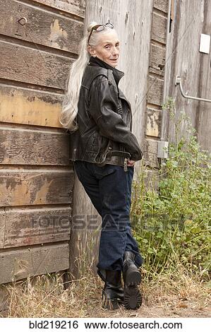 Older Caucasian woman leaning on wooden wall View Large Photo Image Stock Photograph - Older Caucasian woman leaning on wooden wall. Fotosearch