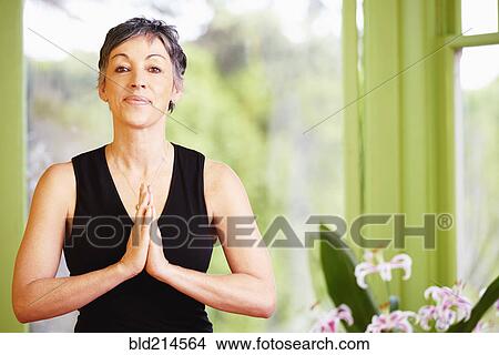 Picture - Older Caucasian woman meditating. Fotosearch