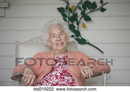 Older Caucasian woman sitting on patio View Large Photo Image Stock Image - Older Caucasian woman sitting on patio. Fotosearch