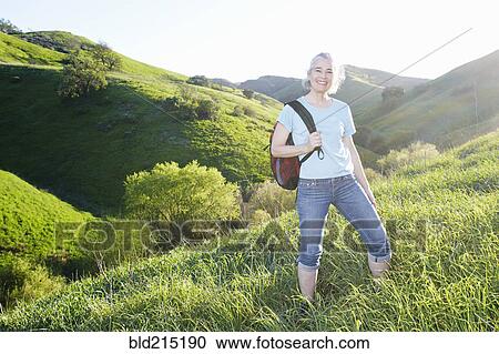 Older Caucasian woman smiling on grassy hillside View Large Photo Image Stock Image - Older Caucasian woman smiling on grassy hillside. Fotosearch