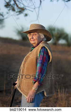 Older Caucasian woman walking with cane in field View Large Photo Image Picture - Older Caucasian woman walking with cane in field. Fotosearch