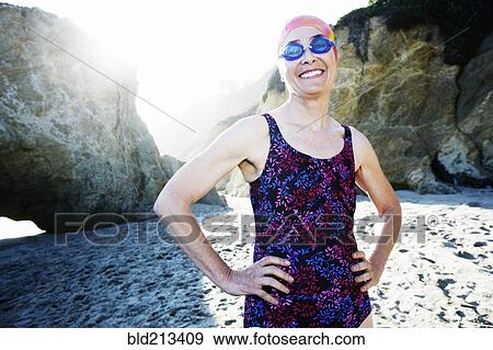 Older Caucasian woman wearing goggles and swimsuit on beach View Large Photo Image Stock Photo - Older Caucasian woman wearing goggles and swimsuit on beach. Fotosearch