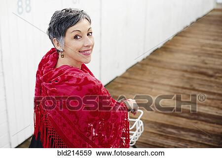 Older Caucasian woman with red shawl riding bicycle View Large Photo Image Stock Photo - Older Caucasian woman with red shawl riding bicycle. Fotosearch