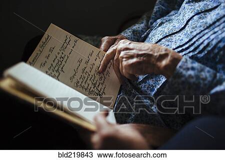 Older woman reading handwriting to granddaughter View Large Photo Image Stock Image - Older woman reading handwriting to granddaughter. Fotosearch
