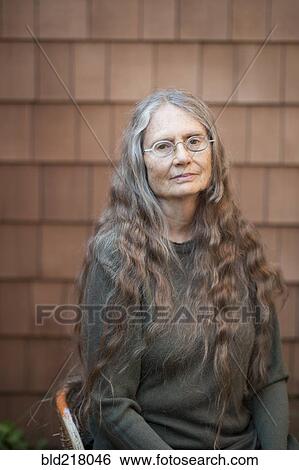 Stock Photograph - Older woman sitting outdoors. Fotosearch