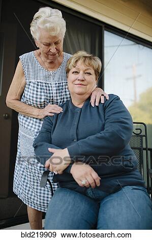Older woman standing with daughter View Large Photo Image Stock Photo - Older woman standing with daughter. Fotosearch