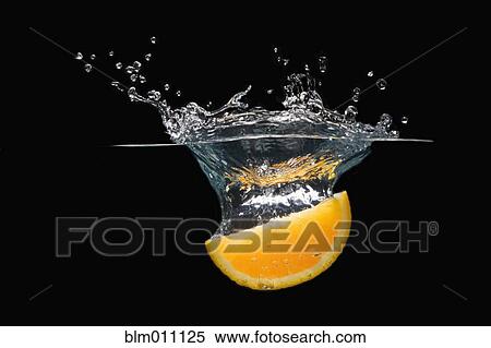Orange slice falling into water View Large Photo Image Stock Photography - Orange slice falling into water. Fotosearch