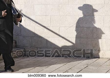 Orthodox Jewish man walking on sidewalk View Large Photo Image Stock Image - Orthodox Jewish man walking on sidewalk. Fotosearch