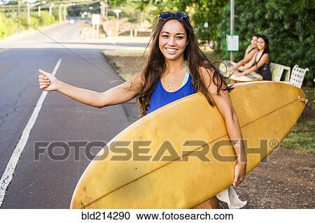Pacific Islander surfer hitch hiking on rural road View Large Photo Image Stock Image - Pacific Islander surfer hitch hiking on rural road. Fotosearch