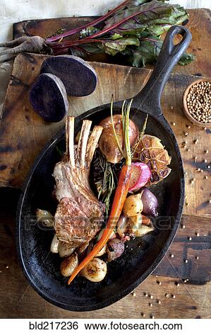 Pan of roasted rack of ribs and vegetables View Large Photo Image Stock Photograph - Pan of roasted rack of ribs and vegetables. Fotosearch