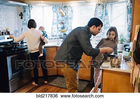 Parents cooking with children in kitchen View Large Photo Image Stock Photograph - Parents cooking with children in kitchen. Fotosearch