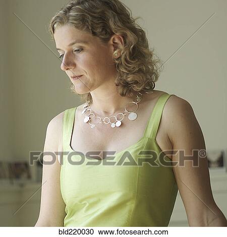 Stock Image - Pensive Caucasian woman looking down. Fotosearch