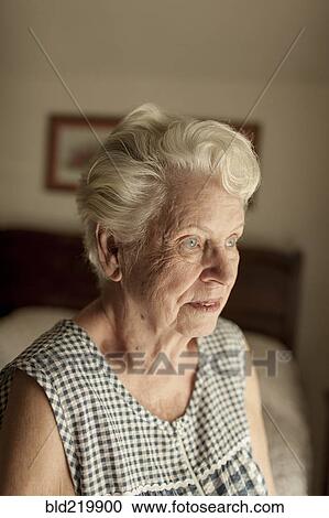 Pensive older woman sitting on bed View Large Photo Image Stock Image - Pensive older woman sitting on bed. Fotosearch