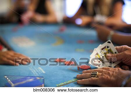 Stock Photograph - People playing poker in casino. Fotosearch