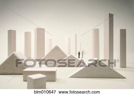 Stock Photo - People standing among large white geometric shapes. Fotosearch
