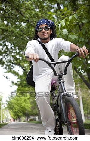 Peruvian man riding bicycle on sidewalk View Large Photo Image Picture - Peruvian man riding bicycle on sidewalk. Fotosearch