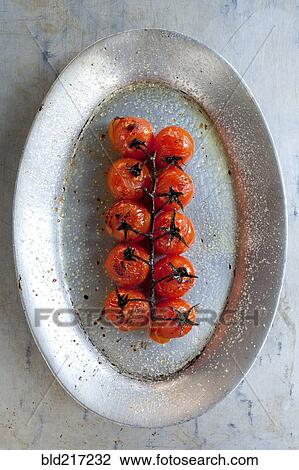 Plate of roast cherry tomatoes on vine View Large Photo Image Stock Image - Plate of roast cherry tomatoes on vine. Fotosearch